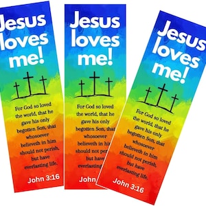 May include: Three colorful bookmarks with the text "Jesus loves me!" and a quote from John 3:16. The bookmarks feature a rainbow gradient background with three black crosses.