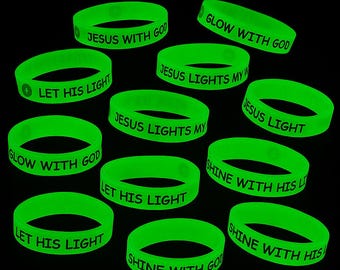 May include: A collection of neon green silicone wristbands. Each band features a different white printed message, including phrases like "Jesus with God," "Let His Light," and "Shine with His." The bands are arranged against a black background.