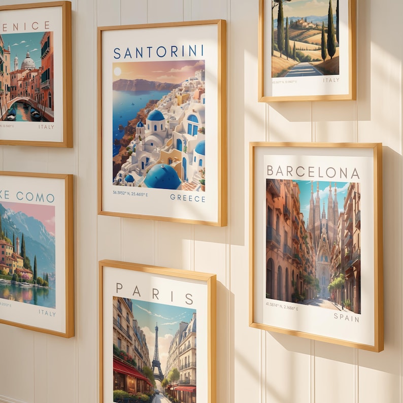 May include: A collection of framed travel art prints featuring iconic locations. The prints showcase scenes from Venice, Santorini, Lake Como, Italy, Barcelona, Paris, and other destinations. Each print is in a wooden frame, creating a cohesive gallery wall.