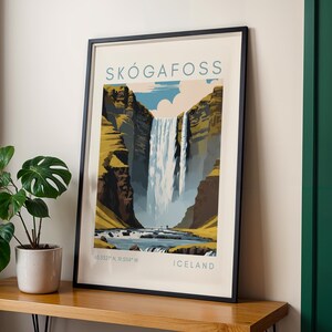 May include: Framed art print of Sk&oacute;gafoss waterfall in Iceland. The artwork features a stylized illustration of the waterfall cascading down a cliff face, with text that reads "SK&Oacute;GAFOSS" and "ICELAND". The print is in a black frame.