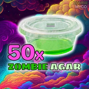 May include: A clear plastic container filled with a bright green liquid. The container is labeled "Zombie Mushrooms" and the text "50x Zombie Agar" is in large pink and green letters.