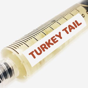 May include: A clear plastic syringe filled with a yellow liquid and labelled "TURKEY TAIL".