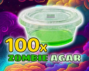 May include: A clear plastic container filled with a bright green liquid. The container is labeled "Zombie Mushrooms" and the text "100x Zombie Agar" is in large yellow and green letters.