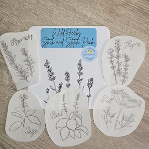 May include: A set of six white fabric sheets with black line drawings of herbs, including rosemary, thyme, sage, basil, dill, and lavender. The sheets are labeled with the name of each herb. The text "Wild Herbs Stick and Stitch Pack" is printed on a blue background.