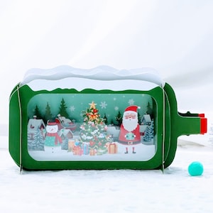 Carte pop-up Père Noël en bouteille - Bonhomme de neige, arbre, cadeaux, bonnet de neige