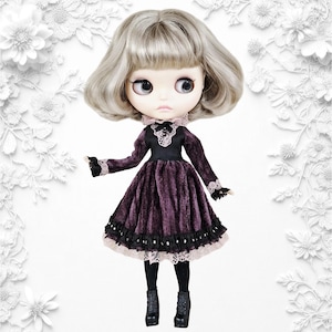 May include: A doll with grey hair and large eyes, wearing a dark purple velvet dress with black lace trim. The doll has black tights and black boots. The background is white with white floral designs.