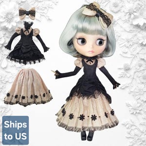 May include: A doll with pale green hair and a large head wearing a black and beige dress with lace trim, a matching bow hair accessory, and black shoes. The set includes an additional black dress with long sleeves and a beige skirt with floral details.