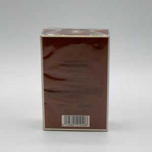 May include: A rectangular brown box with a white border, wrapped in clear plastic. The box has text and a barcode on the front. The top of the box has a logo. The box is on a white background.
