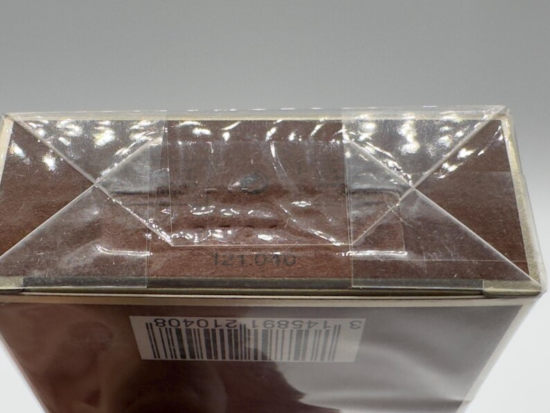 May include: A brown rectangular box sealed in clear plastic. The box has a barcode and the numbers "121040" printed on it. The box is sealed with clear tape.