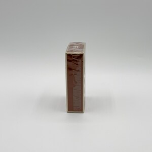 May include: A rectangular, brown box, wrapped in clear plastic, is positioned vertically against a white background. The box appears to be sealed and ready for use. The packaging is simple and clean.
