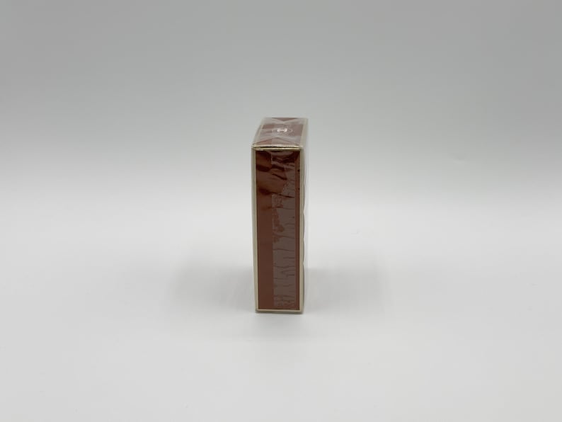 May include: A rectangular, brown box, wrapped in clear plastic, is positioned vertically against a white background. The box appears to be sealed and ready for use. The packaging is simple and clean.