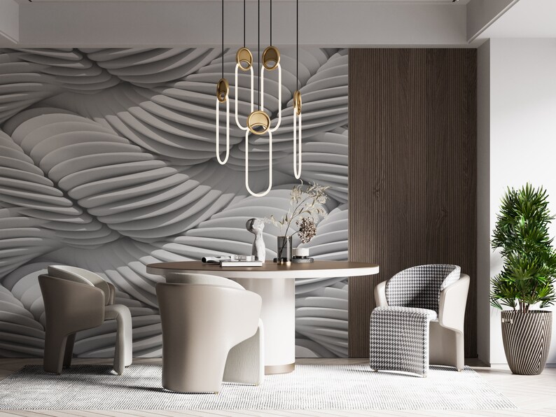 May include: A modern dining room with a white and gray patterned wall, a round wooden table, and four chairs. Two chairs are beige and two are black and white checkered. A gold and white pendant light hangs above the table.