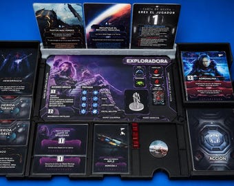 May include: A board game set with various cards and game pieces. The set includes cards with images of characters and text in Spanish. The game board features a central area with character illustrations and game mechanics.
