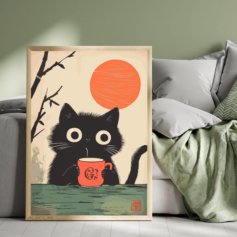 May include: Framed art print featuring a black cat sipping from a red mug. The cat has large, round eyes and is set against a backdrop of a rising orange sun and bamboo branches. The art has a vintage, Japanese-inspired aesthetic.