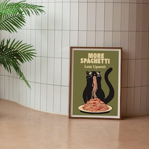 May include: A framed rectangular wall art print featuring an olive green background with a black cat eating a plate of red spaghetti. The text at the top reads MORE SPAGHETTI Less Upsetti in cream-colored lettering. The print has a brown wooden frame.