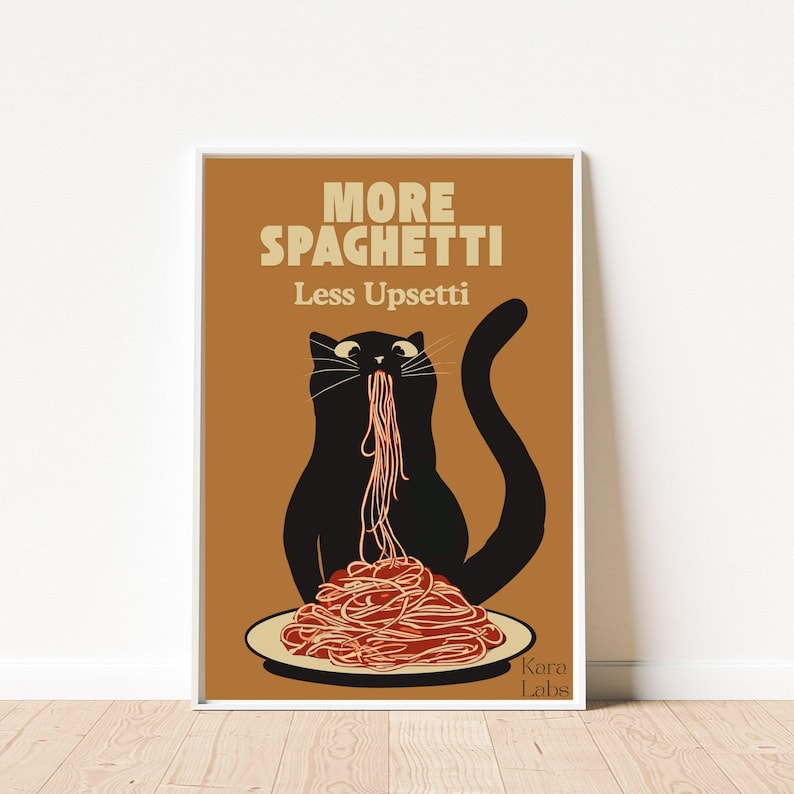 May include: A rectangular wall art print featuring a black cat on a brown background eating a pile of red spaghetti from a white plate. The text reads MORE SPAGHETTI Less Upsetti in cream letters, with the small text Kara Labs in the bottom right corner.