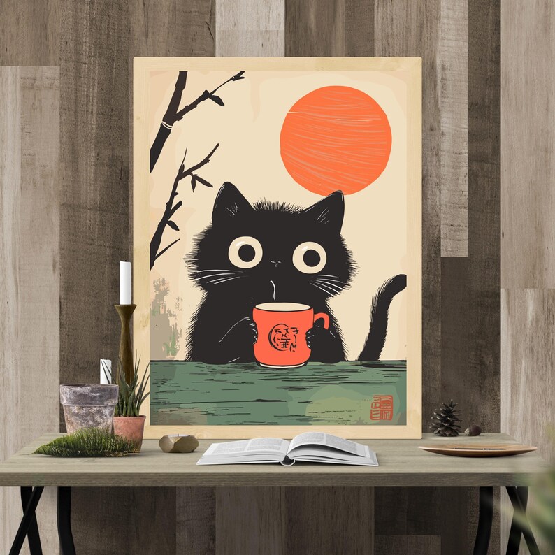 May include: A whimsical art print featuring a black cat with large eyes, holding a red mug with a logo, set against a backdrop of a rising orange sun and bamboo. The cat is positioned on a green surface, creating a charming, illustrative scene.