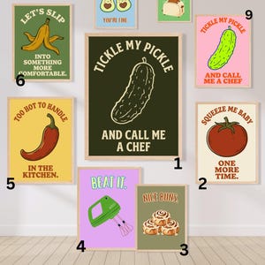 May include: A collection of nine framed wall art prints featuring food-themed illustrations and humorous text. Designs include a pickle, tomato, cinnamon rolls, hand mixer, chili pepper, banana, avocado, and toaster, each with unique captions.