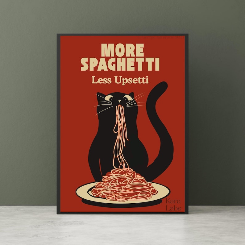 May include: A rectangular wall art print with a dark red background featuring a black cat eating spaghetti from a white plate. The text reads MORE SPAGHETTI Less Upsetti in cream-colored letters. The bottom right corner includes the text Karo Labs.