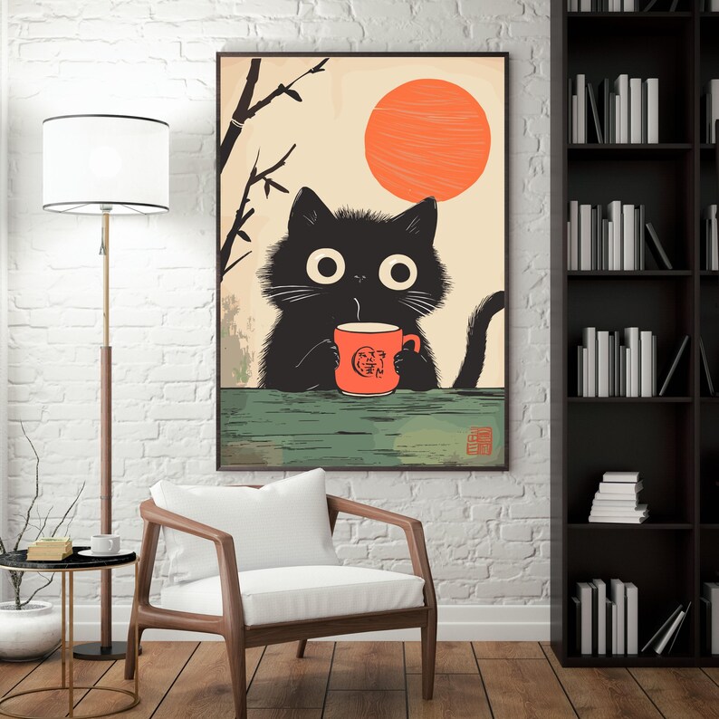 May include: A framed art print featuring a black cat holding an orange mug with a logo, set against a backdrop of a rising sun and bamboo branches. The cat has large, round eyes.