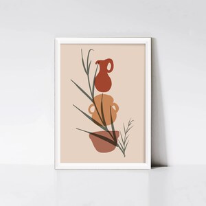 Peut inclure: Une impression encadrée avec un design minimaliste représentant une pile de trois pots en terre cuite avec une branche feuillue devant. Les pots sont dans des tons d'orange, de brun et de rouge sur un fond pêche clair.