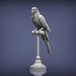 May include: A grey parrot sculpture perched on a wooden dowel, mounted on a decorative pedestal. The bird's feathers are intricately carved, and the sculpture has a smooth, matte finish. The background is a solid, muted blue.