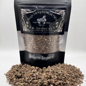 May include: A black resealable pouch containing dried, brown, and green mullein leaves. The label features the text Mags Metaphysical Gifts & Apothecary, Est 2022, and Mullein Leaves. A pile of the same dried, textured herbal material sits in front.