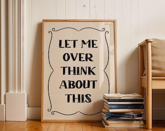 May include: A framed print with a beige background and black text that reads "Let me over think about this". The print is leaning against a stack of books.