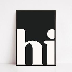 May include: A framed art print with a minimalist design. The artwork features the word "hi" in bold, white, rounded sans-serif font against a black background. The frame is a thin, dark colour, and the overall aesthetic is modern and simple.