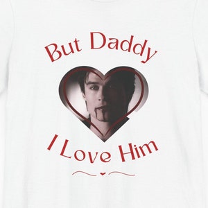 May include: White t-shirt with a red heart graphic featuring a man's face and the text "But Daddy I Love Him".
