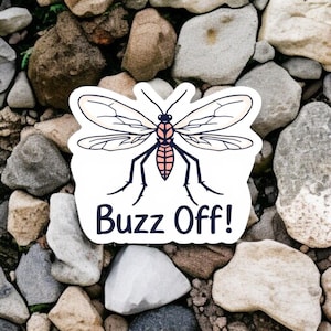 May include: White sticker featuring a stylized mosquito illustration with the text "Buzz Off!" The insect has detailed wings, a pink and black body, and black legs. The sticker is set against a background of gray and brown rocks.