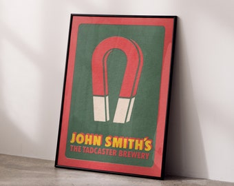 May include: A framed poster with a red and green color scheme. The poster features a large red horseshoe magnet with the text "John Smith's The Tadcaster Brewery" in yellow.