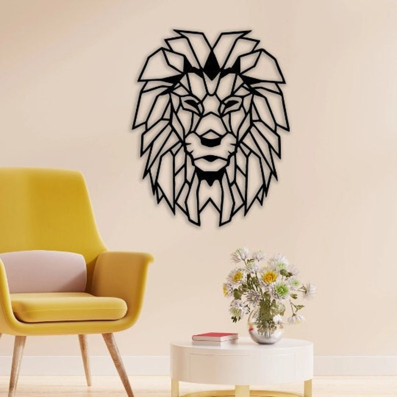 May include: A black wall-mounted lion head sculpture featuring a geometric, angular design with sharp lines and a stylized mane. The piece is constructed from thin, flat material and displays a symmetrical, abstract representation of a lion face.