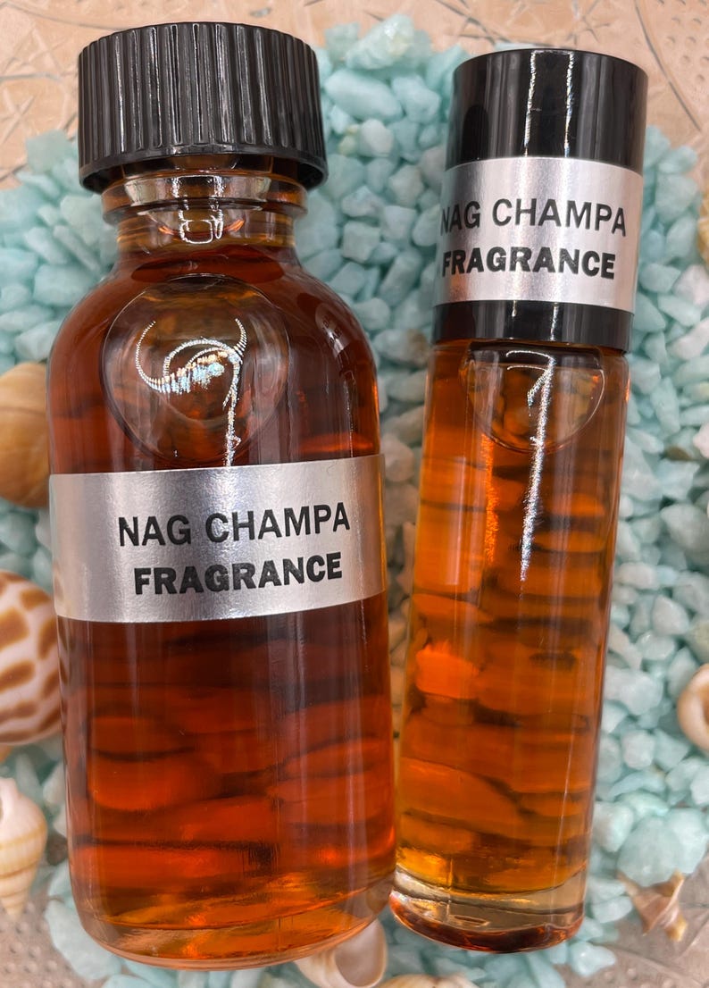 Pu&ograve; includere: Due bottiglie di olio profumato Nag Champa. Le bottiglie sono entrambe di colore ambrato e hanno tappi neri. La bottiglia pi&ugrave; grande ha un'etichetta argentata con il testo "Nag Champa Fragrance" stampato su di essa. La bottiglia pi&ugrave; piccola ha un'etichetta argentata con il testo "Nag Champa Fragrance" stampato su di essa.