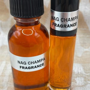 Pu&ograve; includere: Due bottiglie di vetro ambrato con tappi neri ed etichette argentate che recitano "Nag Champa Fragrance".