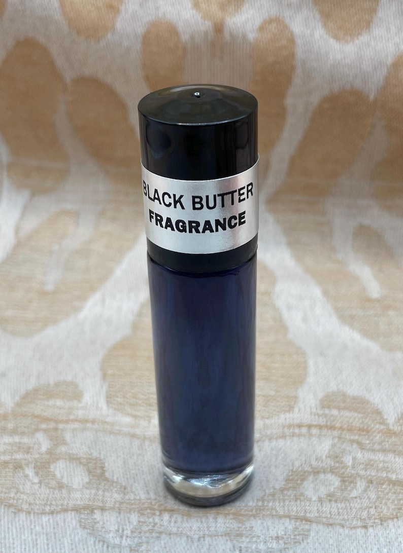 May include: A black roll-on bottle with a silver label that reads "Black Butter Fragrance".