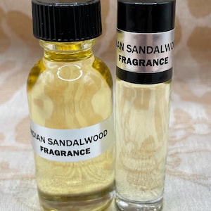 May include: Two bottles of Indian Sandalwood fragrance oil. One bottle is a roll-on and the other is a glass bottle with a black cap.