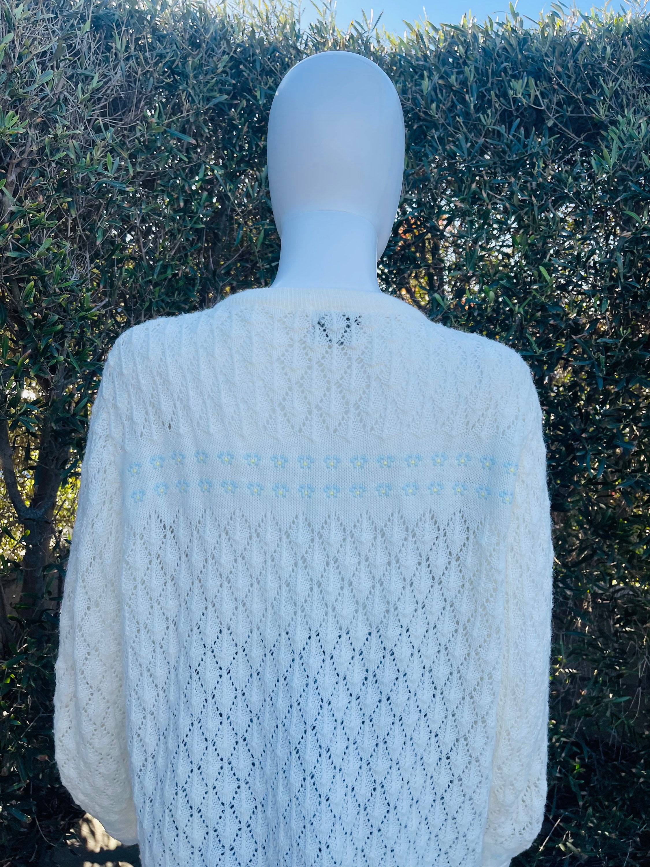 White knit twin set with blue embroidery