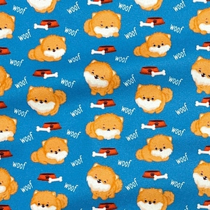 May include: Blue fabric with a repeating pattern of cartoon Pomeranian dogs, dog bowls, and bones. The word "woof" is scattered throughout the design. The dogs are orange and white, and the bowls are red and brown.