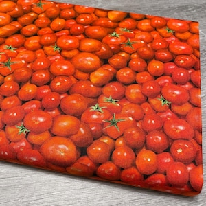 May include: A close-up of a fabric with a repeating pattern of ripe, red tomatoes. The tomatoes have green stems and are densely packed together. The fabric has a slight sheen and is likely used for kitchen decor.