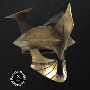 May include: A gold helmet with intricate details and a pointed top. The helmet has a textured surface and appears to be made of metal.