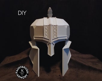 May include: A grey DIY helmet with detailed geometric patterns, including a central crest and cheek guards. The word "DIY" is printed in white. The logo "PAINTBRUSH ARMORY" is also visible.