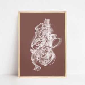 May include: Abstract art print with white chalk-like lines on a brown background. The print is framed in a gold frame.