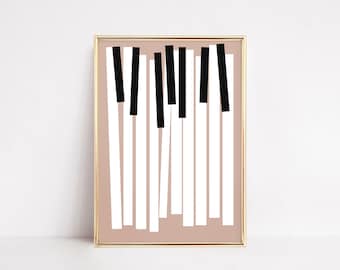 May include: Abstract art print featuring a minimalist design of black and white piano keys on a light brown background. The print is framed in a gold frame.