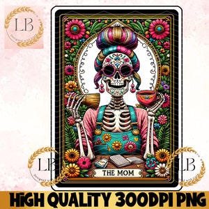 May include: A colorful illustration of a skeleton woman with a sugar skull face, wearing a pink and blue outfit and holding a cup of coffee. The image is set against a background of flowers and leaves. The text "THE MOM" is printed below the image.