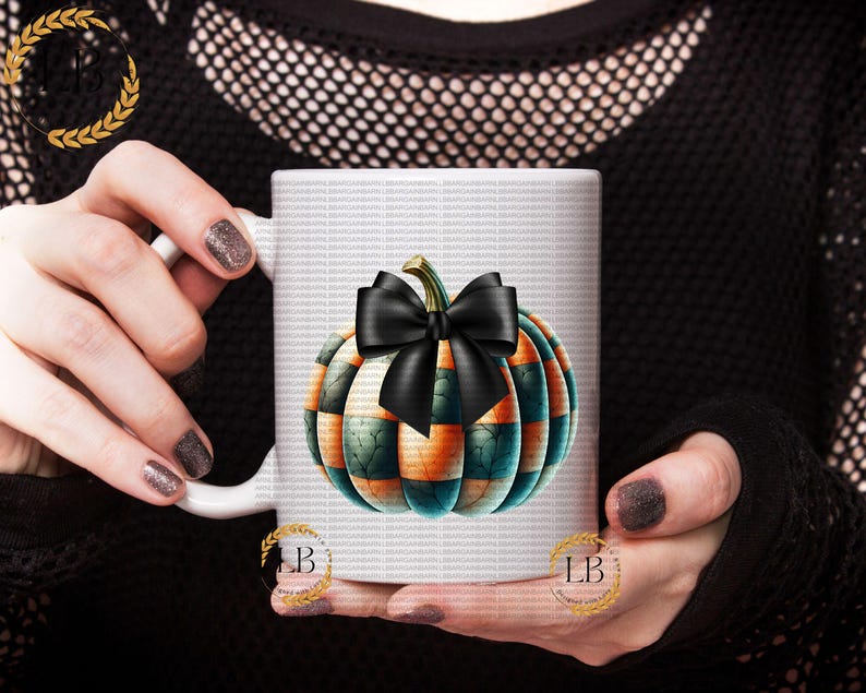May include: White ceramic mug with a black and green pumpkin design. The pumpkin has a black bow and orange and green stripes.