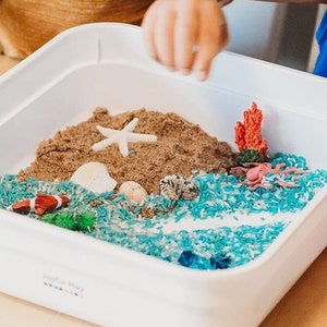 Kids setting up their sensory play kit with all the different items included.