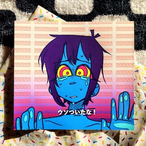 May include: A blue and purple cartoon character with large eyes and a worried expression. The character is crying and has their hands raised in the air. The background is a gradient of pink and yellow with a pattern of question marks. The text "ウソついたな!" is written in Japanese on the image.