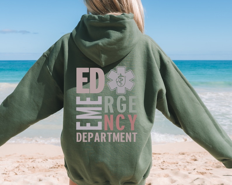 May include: Green hooded sweatshirt with the text "ED EMERGENCY DEPARTMENT" in pink and white letters with a star of life symbol in grey.