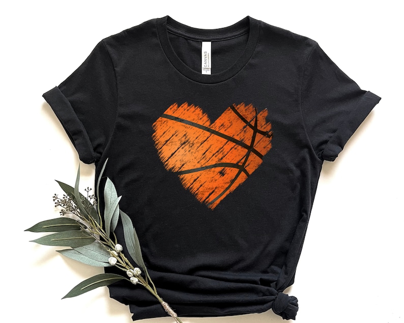 May include: Black t-shirt with a distressed orange basketball shaped heart graphic.